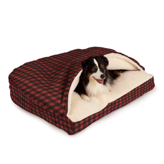 Cozy Cave rectangular dog bed with plaid exterior and a happy dog peeking out of the opening.