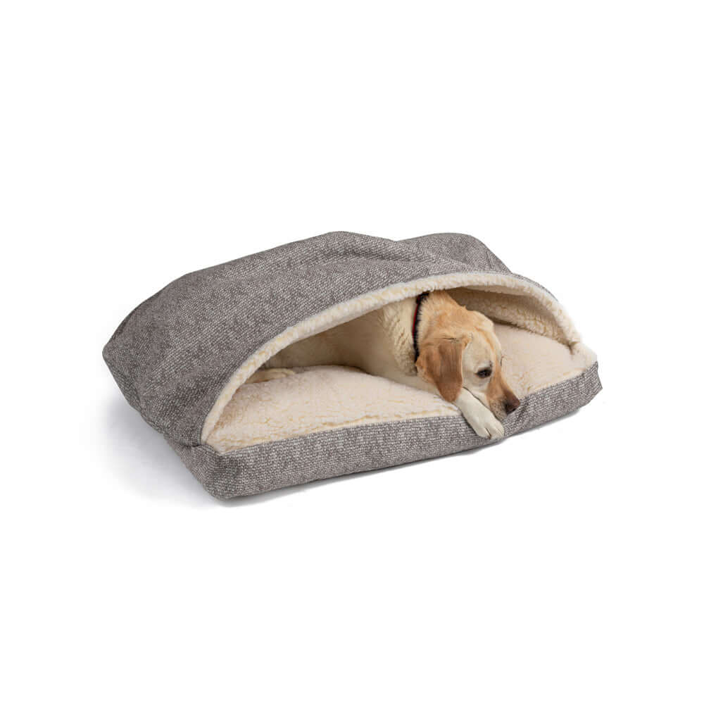 Dog resting in a Luxury Cozy Cave Rectangle Bed with soft sherpa interior and elegant microsuede exterior.
