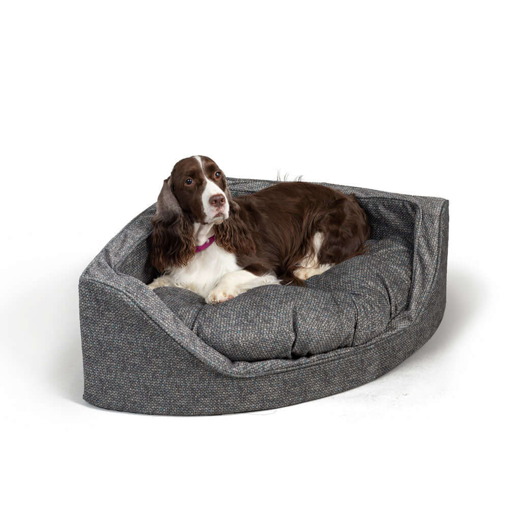 Large corner bed for pets with removable cover, featuring high-density foam and comfortable tufted cushion.