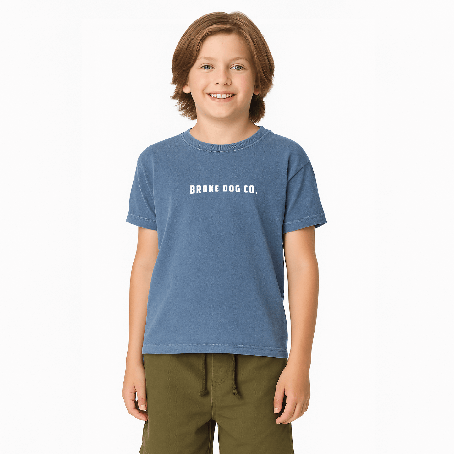 Child wearing a blue washed denim tee from Broke Dog Co, featuring the text 'BROKE DOG CO'.