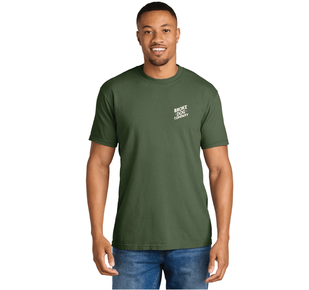 Man wearing a green 'Broke Dog Co.' t-shirt with a relaxed fit, showcasing a playful dog lover theme.