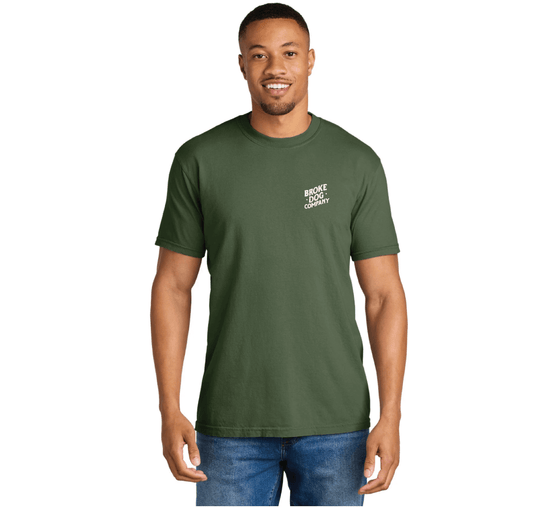 Man wearing a green 'Broke Dog Co.' t-shirt with a relaxed fit, showcasing a playful dog lover theme.