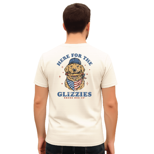 Back view of a man wearing 'Here For The Glizzies' summer t-shirt featuring a golden retriever design.
