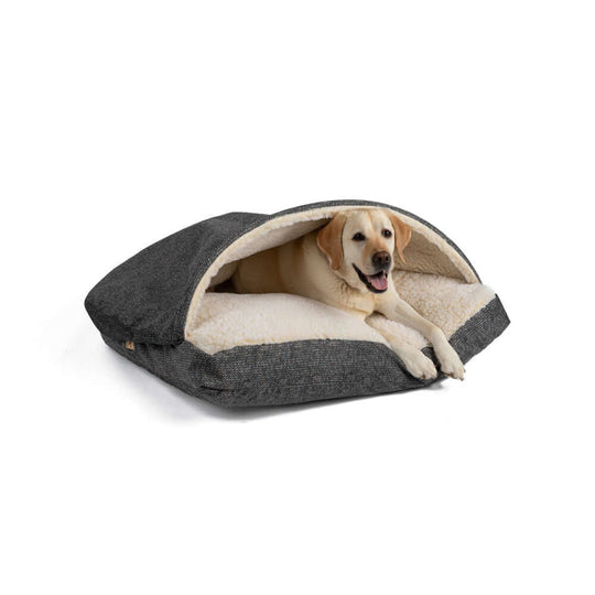 Cozy Cave rectangle dog bed in microsuede and Sherpa, with a happy Labrador retriever lounging inside.