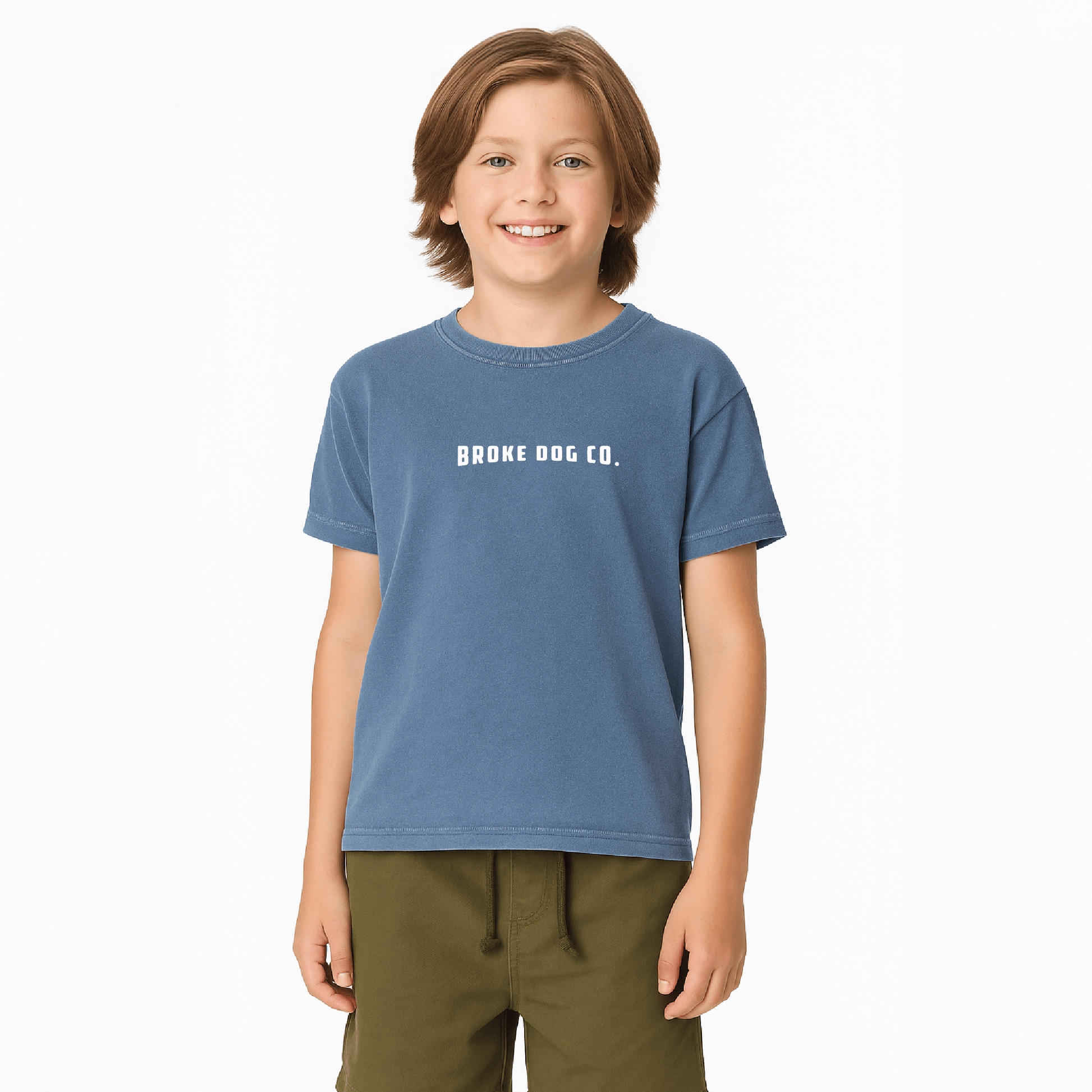 Child wearing a blue washed denim tee from Broke Dog Co, featuring the text 'BROKE DOG CO'.