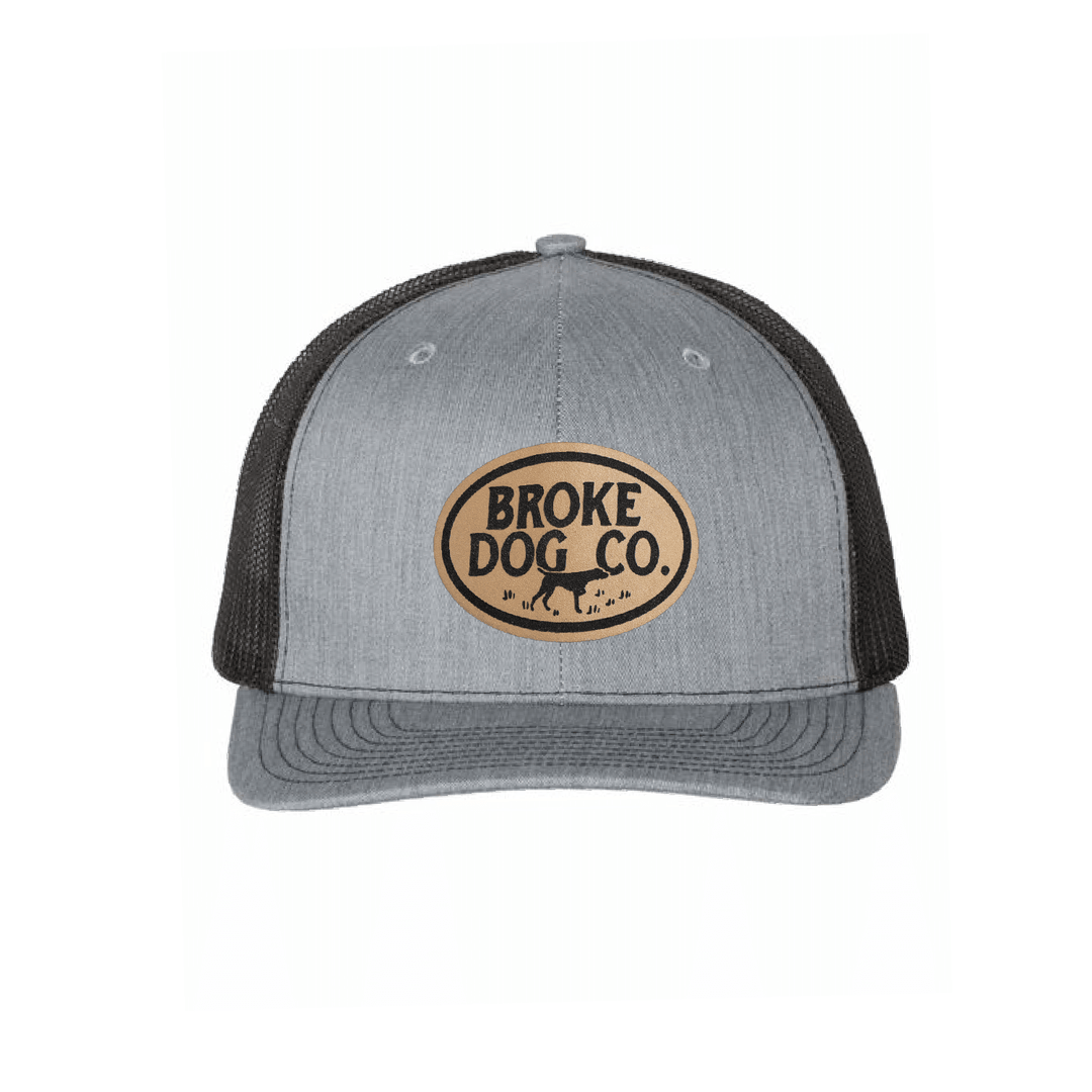 Broke Dog Co. trucker cap in heather gray and black with leather patch, perfect for dog lovers.