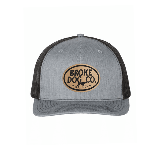 Broke Dog Co. trucker cap in heather gray and black with leather patch, perfect for dog lovers.