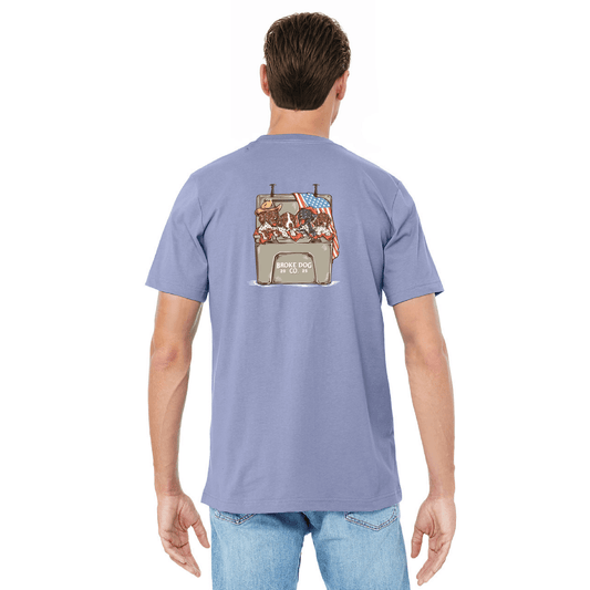 Back view of blue lavender Cooler Pups tee showcasing playful dogs with American flags, perfect for summer festivities.